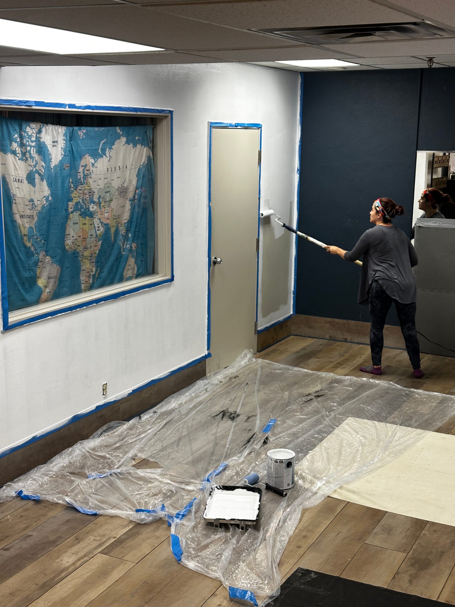 Maritza painting the space a clean, bright white!